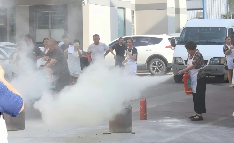 YILI employee practicing proper fire extinguisher technique during safety training YILI employee practicing proper fire extinguisher technique during safety training