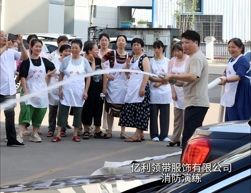 YILI employee operating fire hydrant water hose during factory safety drill YILI employee operating fire hydrant water hose during factory safety drill
